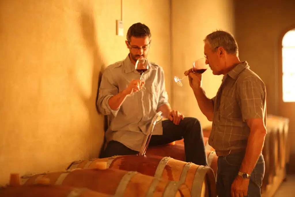 Two men drinking Baron de Monte-Carlo wine